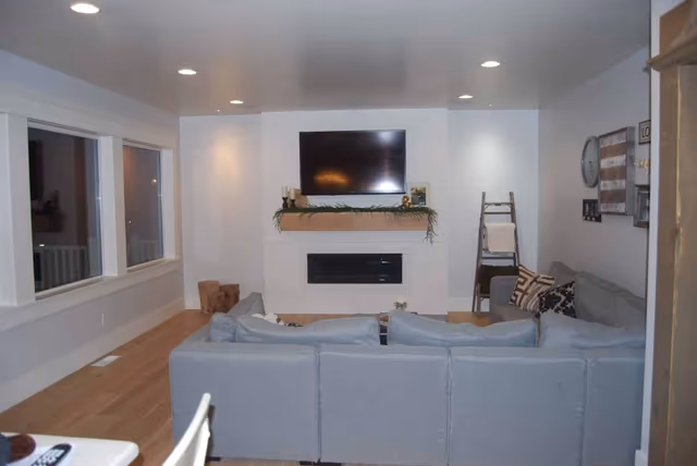 Finished living area with a fireplace and wood-look flooring